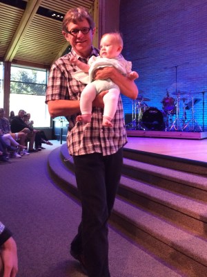 Proud Papa dedicating his first granddaughter at Bethany Community Church.